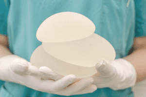 Surgeon holding breast implants