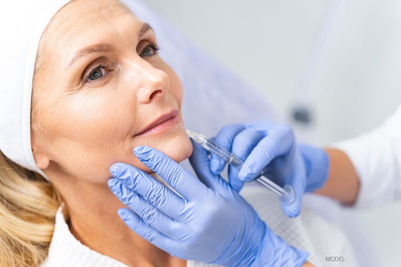 Woman getting an injectable in lower face. 